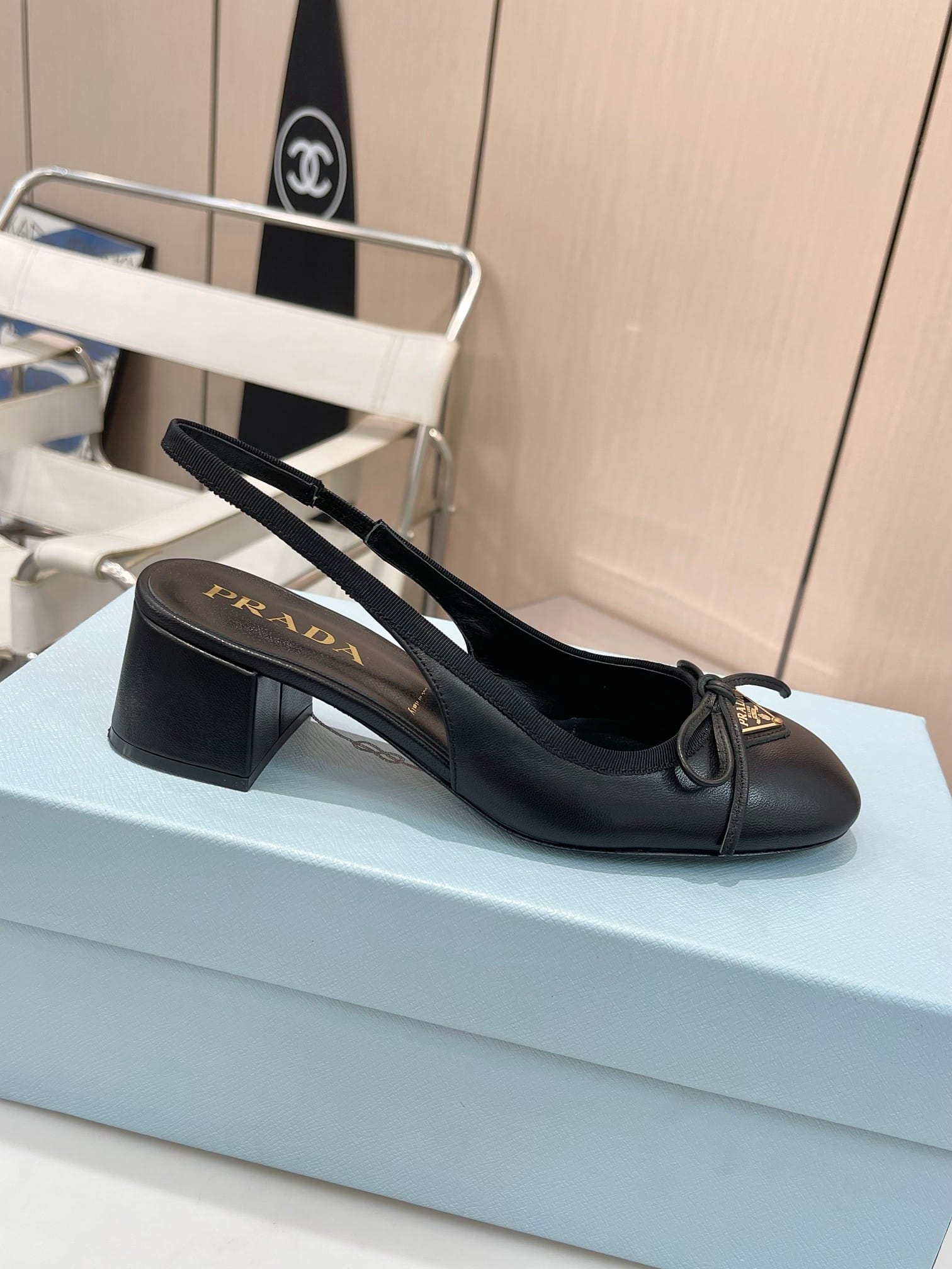 PRADA TRIANGLE LOGO BOW SLINGBACK PUMP IN BLACK - Image 5